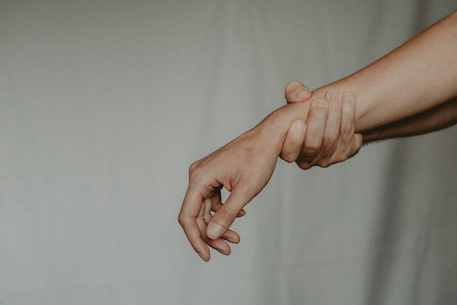 Woman holding her wrist for collagen for menopause and joint health.